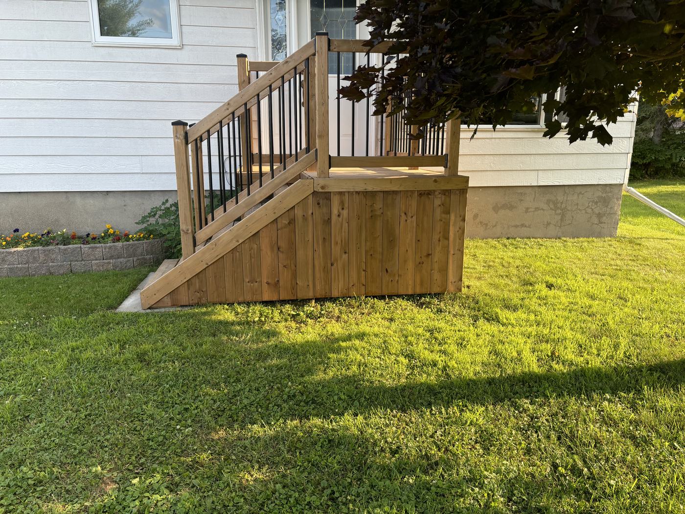 Finished front deck with railings and stairs