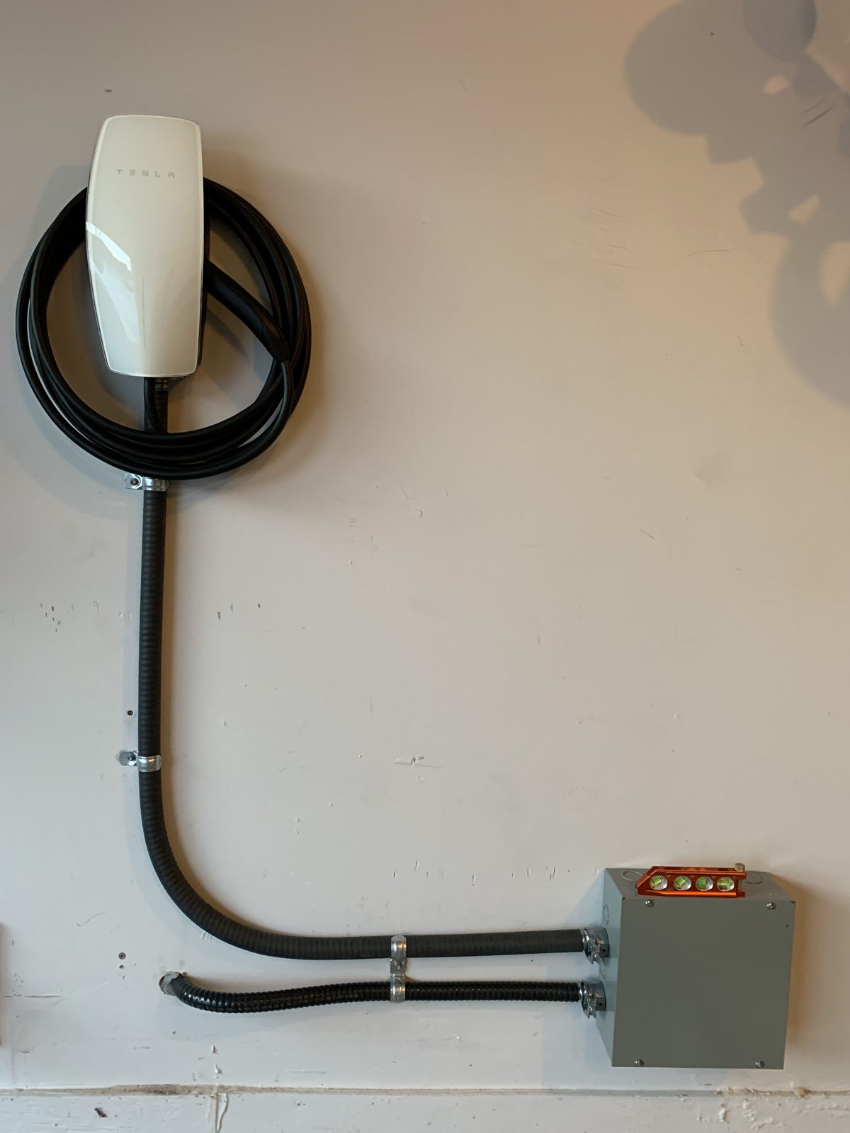 Tesla EV charger installation with clean conduit run