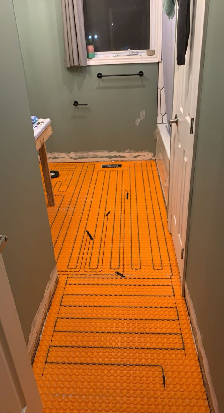 Electric heated floor matting installed before tiling