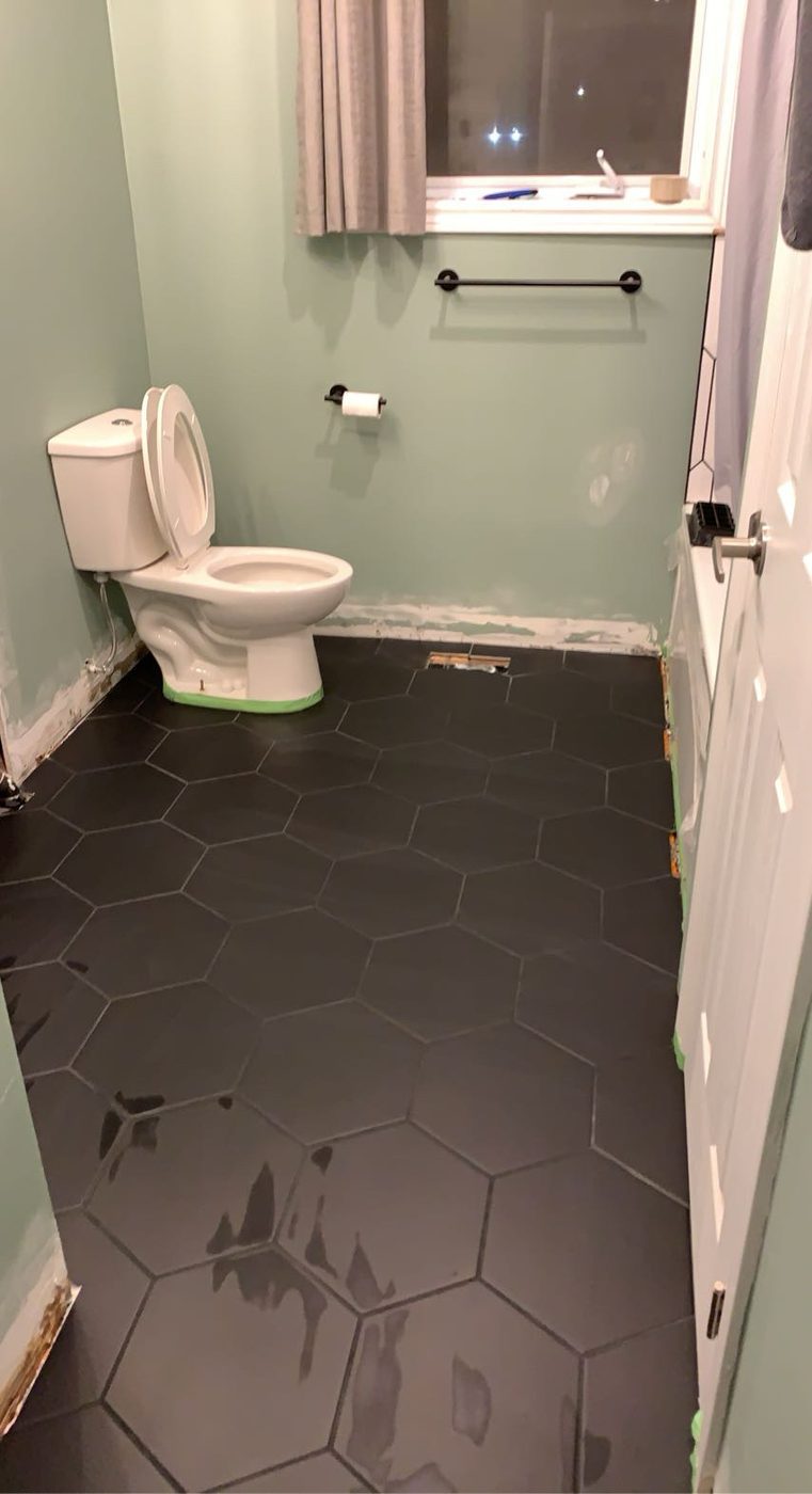 Finished black hexagon tile bathroom floor
